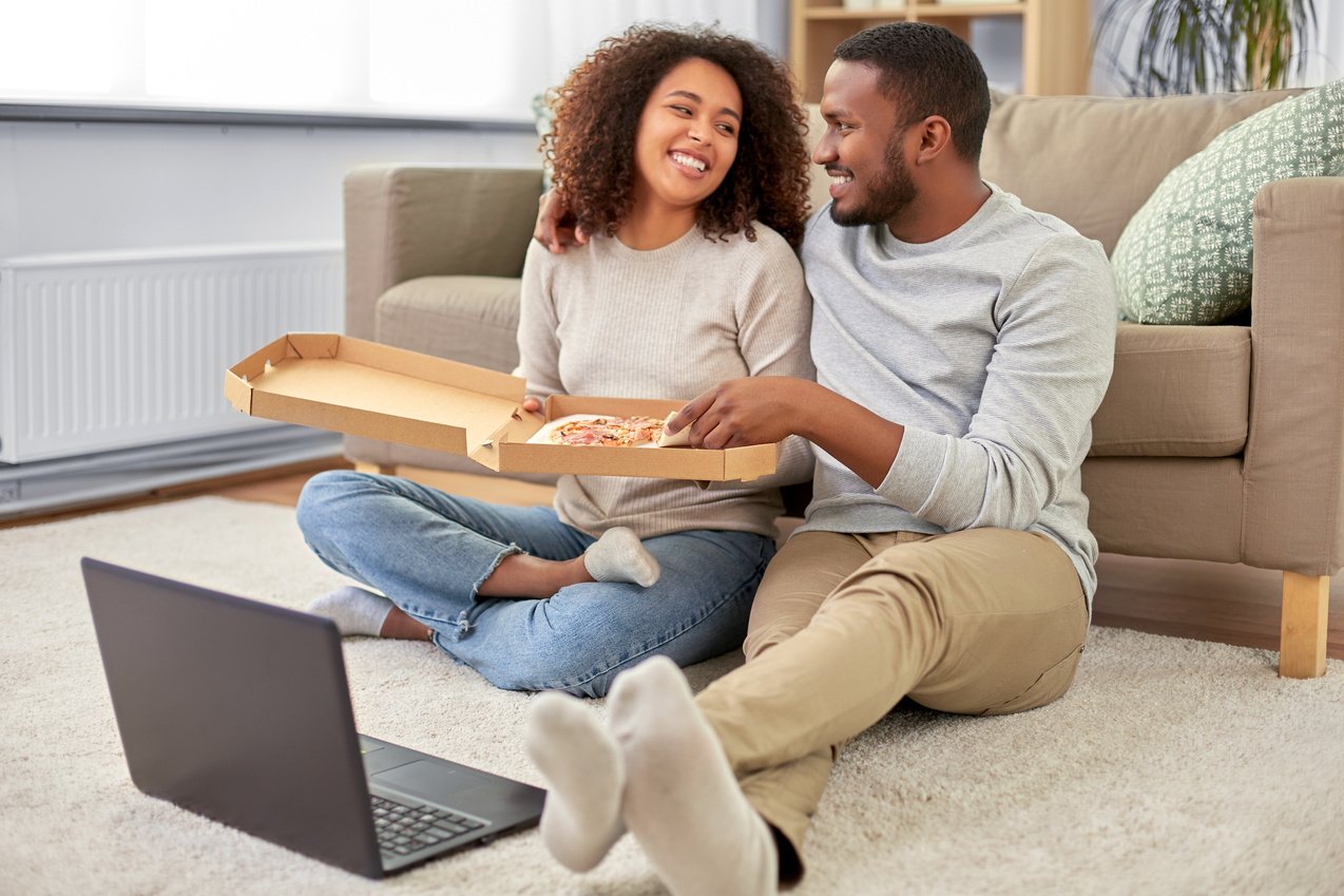 Happy Couple Eating Pizza at Home